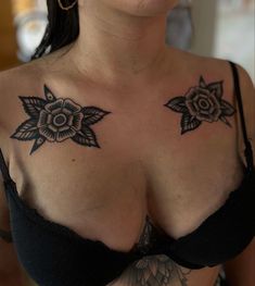 a woman with tattoos on her chest wearing a bra