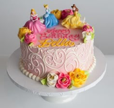 a birthday cake decorated with princesses and the words hello stella on it's frosting