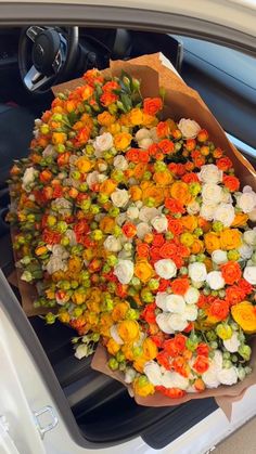 a bouquet of flowers sitting in the back seat of a car