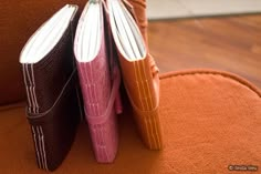 two books are sitting on top of each other in the shape of an open book