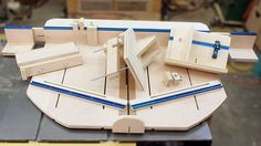 a wooden model of a boat with blue trimmings on the front and sides