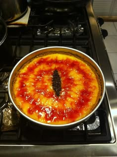 a pizza sitting on top of a stove in a kitchen