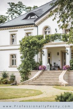 a large white house with steps leading up to it