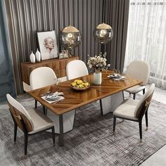 a dining room table with chairs and a bowl of fruit on the table in front of it