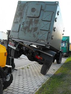 the back end of a dump truck with it's flat bed lifted off to the ground