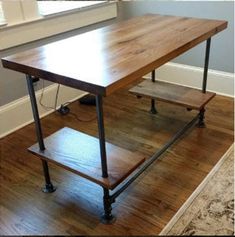 a wooden table sitting on top of a hard wood floor