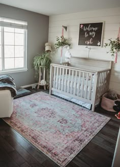 a baby's room with a crib and rug