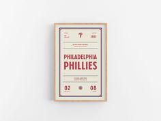 the philadelphia phillies'ticket is displayed on a white wall with red and blue lettering