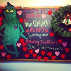 the grinch's heart is hanging next to a christmas wreath and a sign