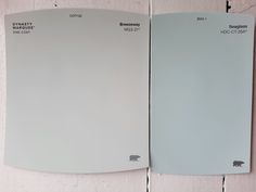 two white papers are on the wall next to each other, one has an elephant sticker on it