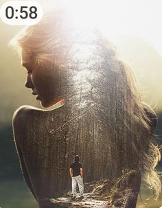 a woman with long hair standing in the woods