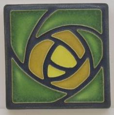 a green and yellow tile with an abstract design