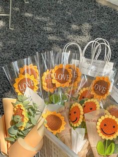 sunflowers are wrapped in cellophane and placed on the ground next to each other