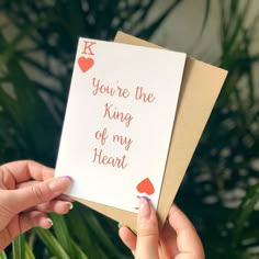 two hands holding up a card that says, you're the king of my heart