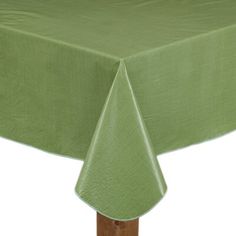 a green tablecloth on top of a wooden table