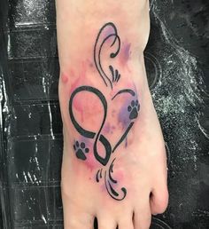 a foot with a tattoo on it that has a dog's paw in the shape of a heart