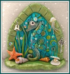 a blue seahorse sitting on top of a green shell next to a starfish