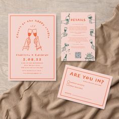 the wedding stationery is laid out on a bed with two cards and envelopes