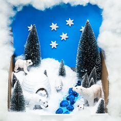 an ornament with polar bears and trees in the snow on a blue background