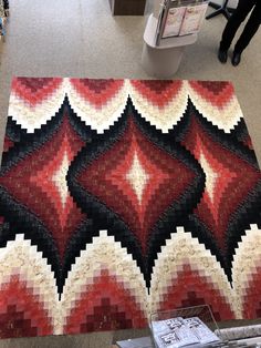 a red and black area rug on the floor