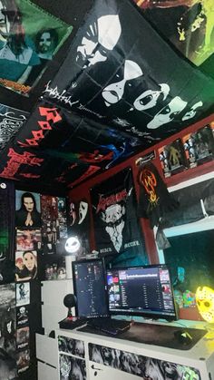 a room filled with lots of different types of posters on the walls and ceiling above it