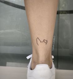 a woman's foot with a small tattoo on her left leg and the word love written in it