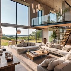 a living room filled with lots of furniture next to tall glass windows on top of a wooden floor