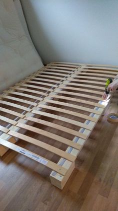 a person laying on the floor with a drill and screwdriver next to a bed frame