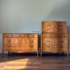 two wooden dressers sitting next to each other on top of a hard wood floor