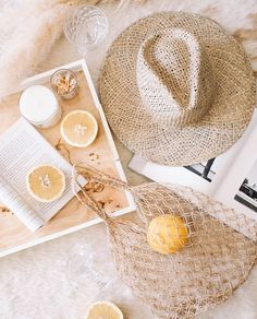 an open book on a table with lemons and other things to make it look like a hat