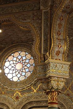 an ornately decorated ceiling with a stained glass window