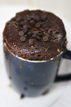 a chocolate cake in a blue cup on a white plate