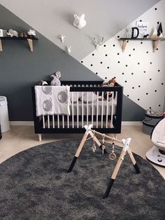 a baby's room is decorated in black, white and grey colors with polka dots on the walls