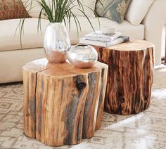 two wooden tables sitting on top of a rug next to a white couch and chair