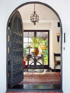 an open door leading to a dining room with a table and chairs in it,