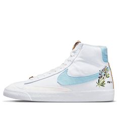 The Nike Blazer Mid '77 is a classic silhouette with a sustainable construction. The shoe's white canvas upper incorporates 20% recycled content by weight, overlaid by tonal synthetic suede and accented by blue on the Swoosh and heel patch, achieved through plant dye. The right heel patch includes a scientific infographic, while the heels of both shoes include an indigo plant graphic. The tongue tag and heel strip are built with recycled cork, with more cork worked into the herringbone rubber ou Scientific Infographic, Nike Blazer Mid 77 White, Plant Graphic, Sustainable Construction, Indigo Plant, Nike Blazer Mid 77, Nike Blazer Mid, Nike Blazers Mid, Blazer Mid