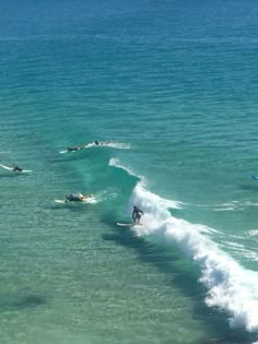 several surfers are riding the waves in the ocean