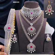 This stunning American diamond necklace and long haar combo set is the perfect accessory for any occasion, especially Indian weddings. The set includes a necklace, hipbelt, mangtikka, and earrings, all made with high-quality CZ stone crystal beads and plated in silver for a long-lasting finish. The necklace is a traditional Indian design, with a long pendant and intricate detailing. The hipbelt is a beautiful addition to the set, and it is sure to accentuate your waistline. The mangtikka is a tr Traditional Wedding Sets With American Diamond, Mangtika Bridal, Diamond Necklace Long, Elegant Statement Necklace, Ruby Diamond Necklace, Unique Wedding Jewelry, American Diamond Jewellery, Extraordinary Jewelry, American Diamond Necklaces