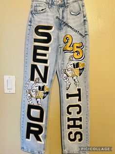 BUYER MUST PROVIDE THEIR OWN JEANS All artwork is hand painted. Design includes a total of 5 images on both pants legs.  Once payment is received, you will receive shipping address. Please allow 6 weeks for completion, starting from the date your jeans have been marked delivered. If you need it sooner, please message us to confirm availability. Rush fee $100 Senior Jeans Black And Gold, College Pants Diy, Hoco Pants Ideas Junior, Senior Pants 2025, Homecoming Pants Decorated, Senior Pants Ideas 2025, Hoco Jeans Painted Ideas, Senior Jeans Painted 2025 Ideas, Senior Jeans Painted 2025