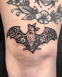 a black and white photo of a bat tattoo