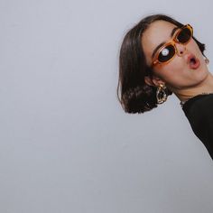 a woman wearing sunglasses making a funny face