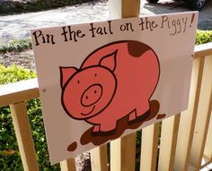 a sign that says, pin the tail on the pigy with a cartoon pig