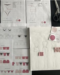 paper cutouts and scissors are on the table next to some sewing patterns for bras