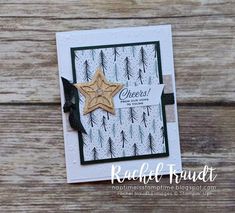 a close up of a card with a star on the front and pine trees on the back