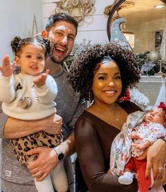 a man, woman and child posing for the camera