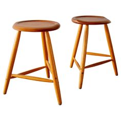 two wooden stools sitting next to each other