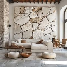 a living room filled with furniture and stone walls