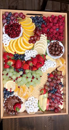 a wooden tray filled with different types of fruit