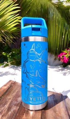 a blue water bottle sitting on top of a wooden table