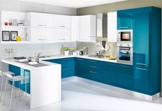 a white and blue kitchen with stools next to the counter top, sink and oven